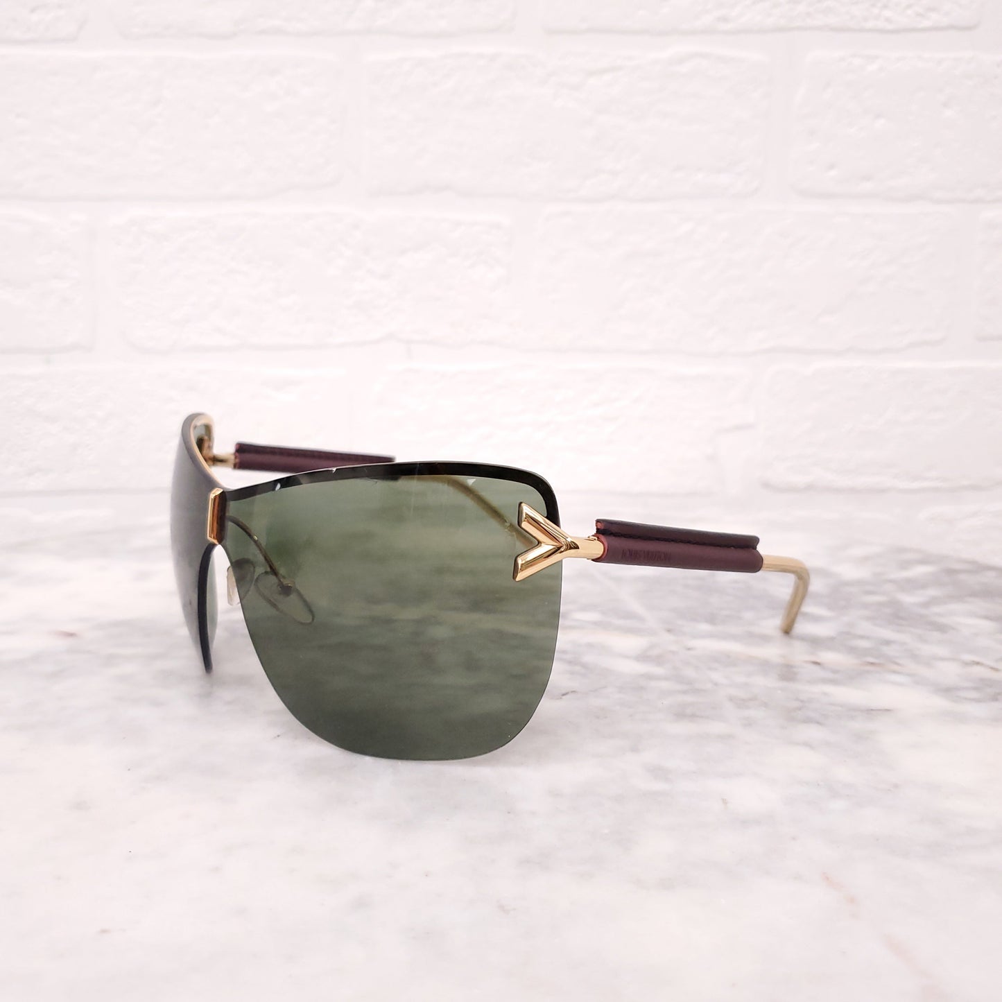 LOUIS VUITTON MASK LOGO SUNGLASSES WITH LEATHER DETAIL